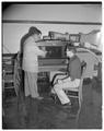 Aero club looks at model wind tunnel, Milosh Popovich assisting, October 1953