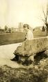 Ruby Stafrin Irwin seated on the east end of the OAC campus, circa 1920
