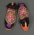 Men's ceremonial shoes of black wool tightly crocheted with colorful yarn embroidery