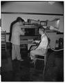 Aero club looks at model wind tunnel, Milosh Popovich assisting, October 1953