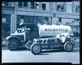 Richfield Oil Co. Richfield Tank Truck and Racing. Car lined up in front of John K. Leander, INC.