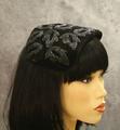 Casque-style hat of a shaped rectangle of black velvet with bead appliques of leaves