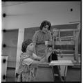 Home Economics students working to upholster a chair, February 1964