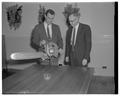 A new chainsaw is demonstrated to Forestry Dean Walter McCulloch