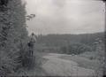 Benjamin A. Gifford standing on stump next to stream