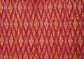 Textile panel (part of a sari) of berry red silk ikat