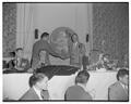 Kip Taylor shakes hands with Jim Clark at a football banquet held in Portland