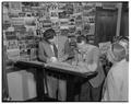 Pinto Colvig (right), also known as Bozo the Clown, signing the guest book in the OSC alumni office, 1951
