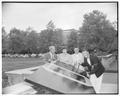 Students and a faculty member posing with the senior class wood carving table