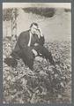 Man sitting on leaf-covered grass, circa 1910