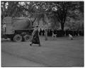 Pouring concrete walk on commencement day as faculty line up for processional in front of library, June 4, 1951