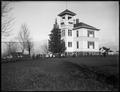 Students in schoolyard of public school, Yamhill, OR. Wooden school building with houses in background.