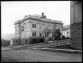 City Hall, Astoria, OR., with stone building and unpaved street in foreground.