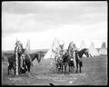 Young Chief, Whirlwind, and No-Shirt, Umatilla Indians in costume, on horseback, at Umatilla Reserve, July 4, 1903. Thumbing White Man for dropping in on US/U.S.