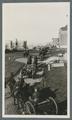 Horse-drawn artillery pieces moving through campus, circa 1920
