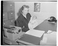 Pat Haag, Secretary to News Bureau, and baby, June 1952