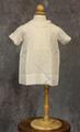 Dress of white cotton with pin pleats at front yoke and round collar with scalloped edge