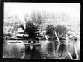 Two rowboats and steam boat on river