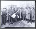 Ground breaking ceremony for Weatherly building, Portland. Group of people surrounding man with large shovel.