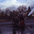 Four firemen using a water cannon