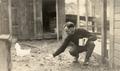 E. E. Wilson feeding a chicken