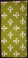 Textile panel of chartreuse green ground with dark green and white fleur-de-lis spade pattern