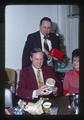 Jack Davis, David Moore, and "Anderson" opening T.J. Starker's present at Koffee Klub Christmas party, Oregon State University, Corvallis, Oregon, December 1975