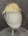 Calot of cream colored feathers with black woven mesh veil