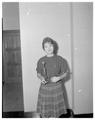Jan Marquiss holding her first place trophies from Western Speech Tournament, 1960
