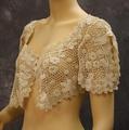 Bolero of ivory crocheted lace in a floral and leaf motif on a lattice-like ground