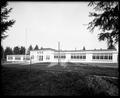 Kennedy School building, Portland. Field and unpaved road in foreground.