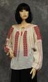 Blouse of ivory cotton gauze with bands of geometric embroidery in red, black and white