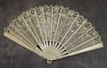 Folding fan of white painted wood sticks hand-painted with tiny flowers in yellow, silver, blue and pink