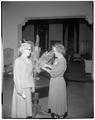 Participants in a Summer Session open house admire a floral arrangement, Memorial Union