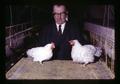 Paul Bernier with dwarf chicken and typical chicken, Oregon State University, Corvallis, Oregon, November 1968