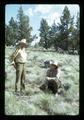 Reub Long and Dean Frischknecht examining range grass in Devils Garden, Lake County, Oregon, circa 1972