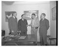 Jess A. Hanson (second from left) awarding a scholarship to a poultry husbandry student