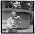 Forest mammologist Ed Hooven posing with a trapped rodent