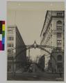 Stark Street scene. Portland, Oregon Looking West from Third Street.  Steel archway over intersection of Stark Streek. (recto)