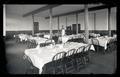 A server posing in the dining room in Cauthorn Hall (present day Fairbanks Hall)