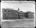 Portland Union Stock Yards Co., North Portland. Large brick building with clock tower and arched windows. Architect's name added in foreground.