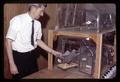 Frank Adams with rats in cage, Oregon State University, Corvallis, Oregon, circa 1970