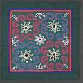 Table Scarf of green cotton with floral embroidery in fuchsia, blue, white, black, red, and purple chain stitch
