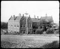 Rear site view, Portland Academy. Gravel road in foreground.