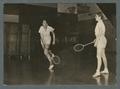 Two women playing badminton in gym class, 1938