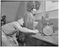 R. W. Peterson, graduate assistant, and Milosh Popovich, staff member, around equipment that tested engine wear in automobiles with radioactive pistons, 1953