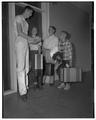 Phil Shadoin, 4-H counselor, with three boys, June 1955