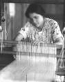 Jane Chase, spinner and weaver, at the loom