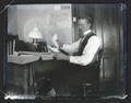 Herman T. Bohlman sitting at a desk