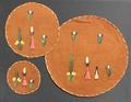 Roundels (set of coasters and placemats) of bright brown barkcloth with embroidered flowers with grass motifs